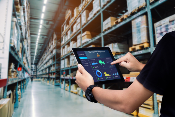 Person holding tablet in digitally enabled warehouse