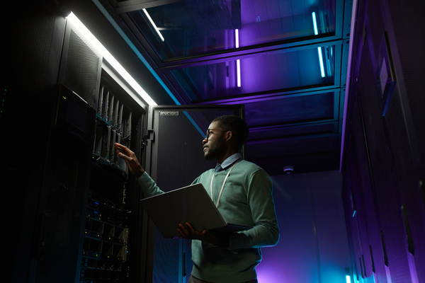 man in data centre with servers